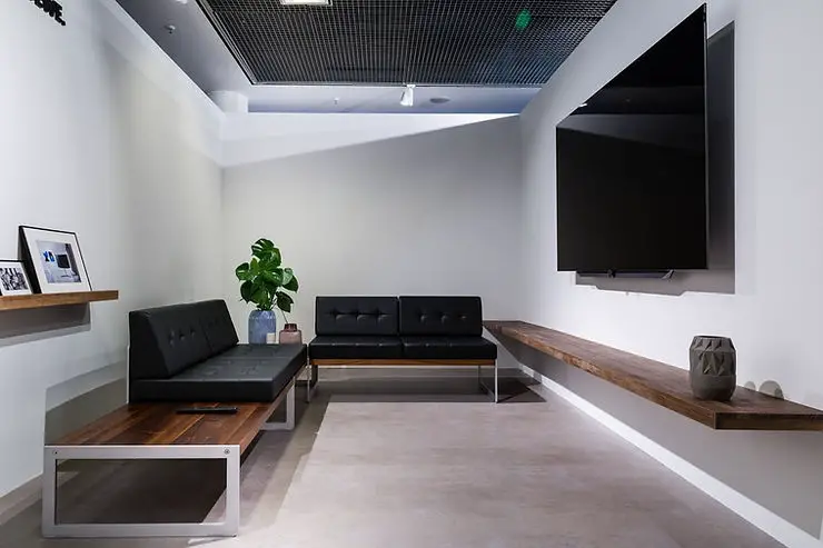 minimalist bachelor living room grey floor and black sofas