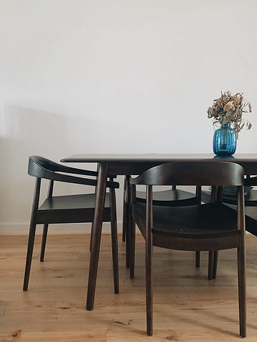 minimalist dark brown dining room with glass flower vase